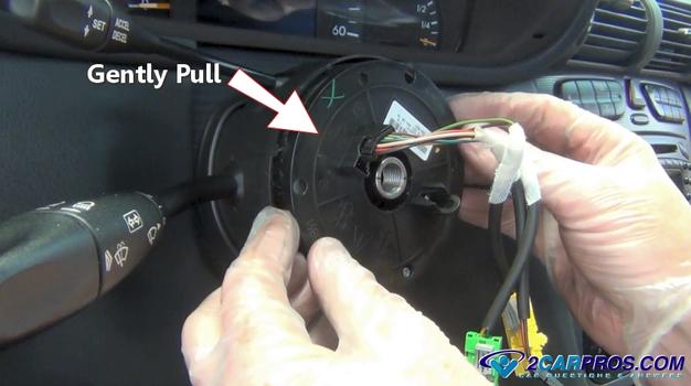 gently pull steering wheel top plate