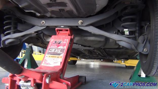 rear car lifted with jack secured by jack stands