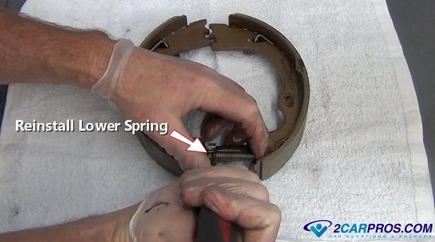reinstall lower parking brake shoe spring