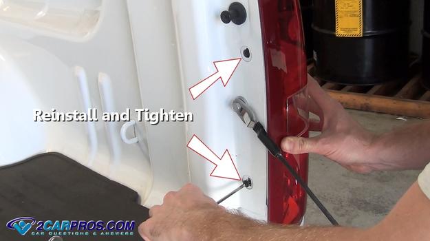 reinstall reverse light bulb lens screws