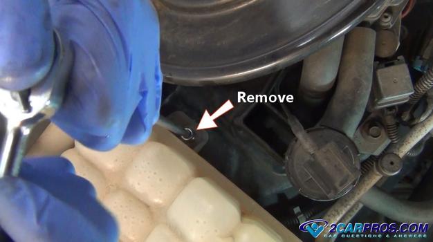 remove automotive engine coolant reservoir mounting bolts