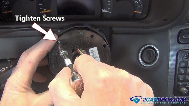 tighten steering wheel clock spring mounting screws